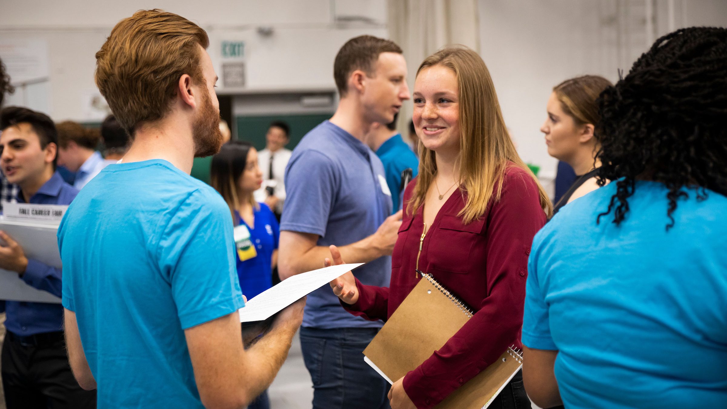 male and female student chat during a career fair